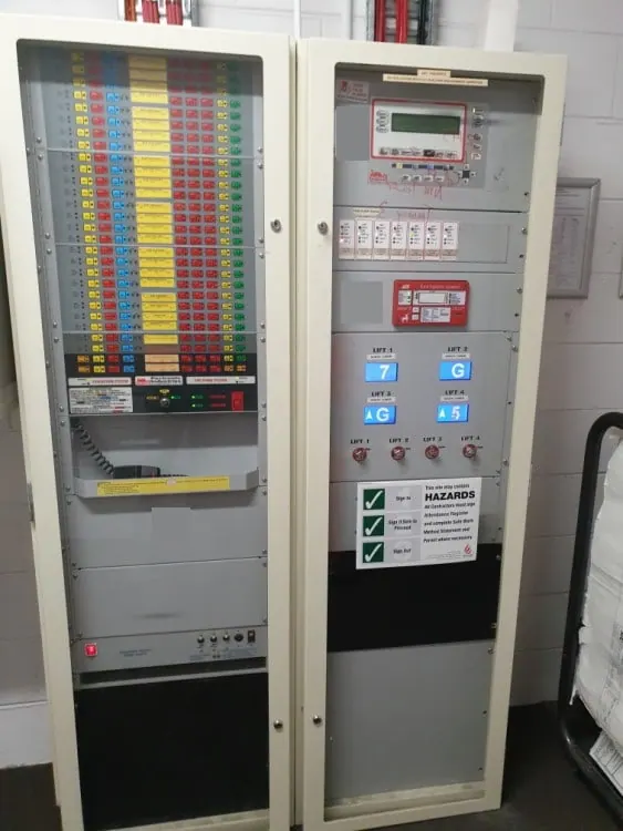 Brooks Firetracker addressable fire indicator panel showing a live fault list, with the occupant warning system controls below, maintained 24/7 by Safe QLD Fire Protection