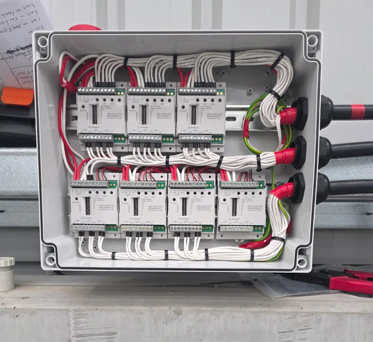 Ampac addressable loop interface modules wired into an enclosure during a new fire detection installation by Safe QLD Fire Protection
