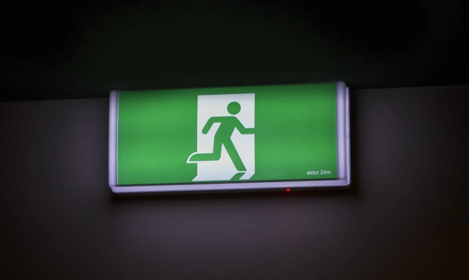 Illuminated green emergency exit sign